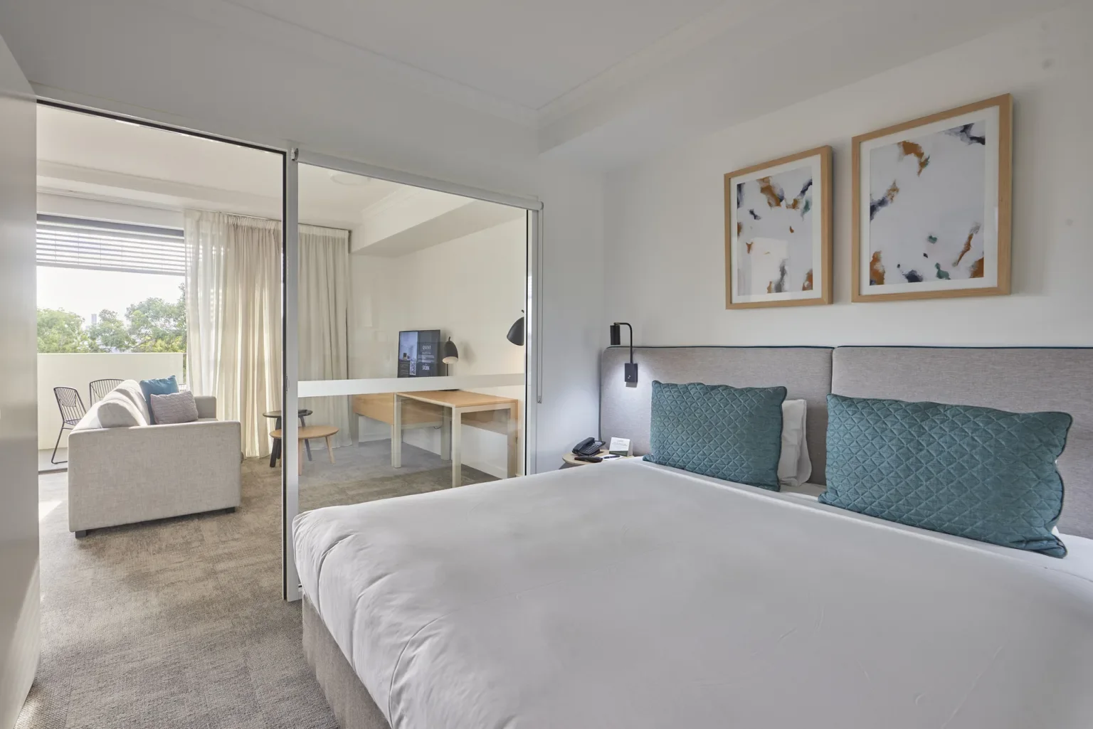 Carpeted bedroom and adjoining living area at Quest Cannon Hill — Airlay project photography