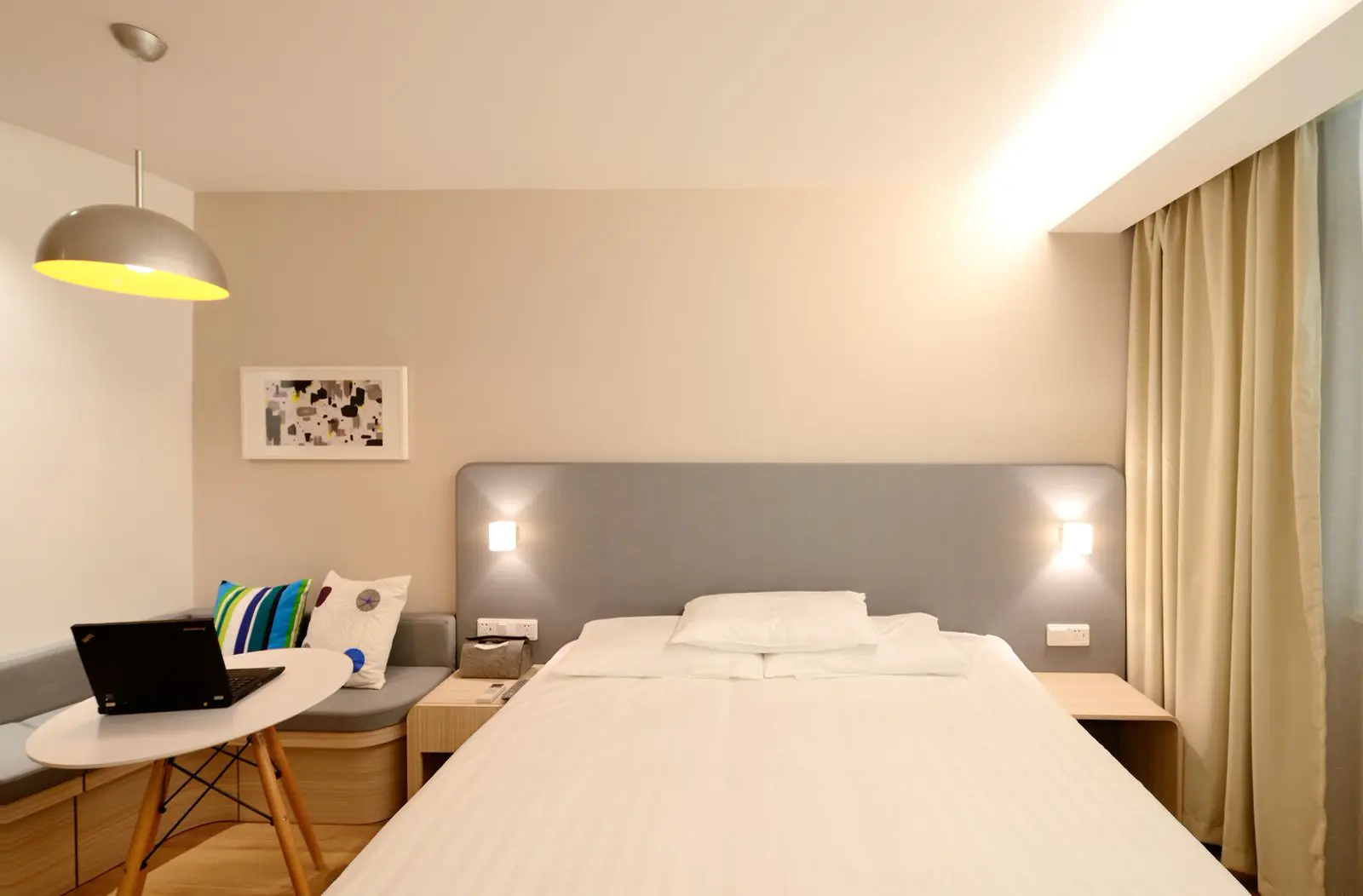 Motel-style bedroom with timber-look flooring — illustrative stock photography